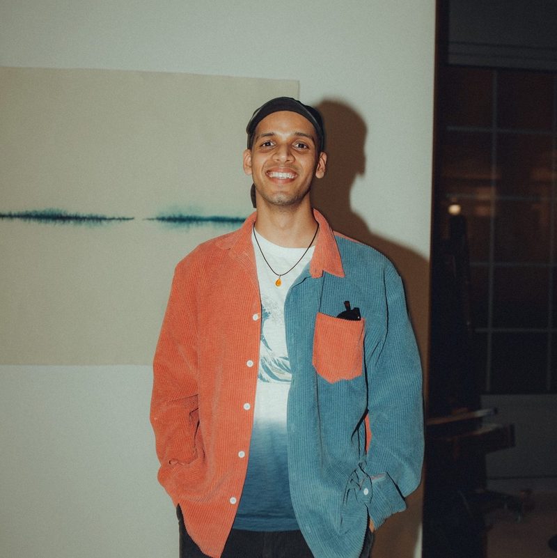 Manoj Pandey, smiling, in an orange and blue corduroy shirt